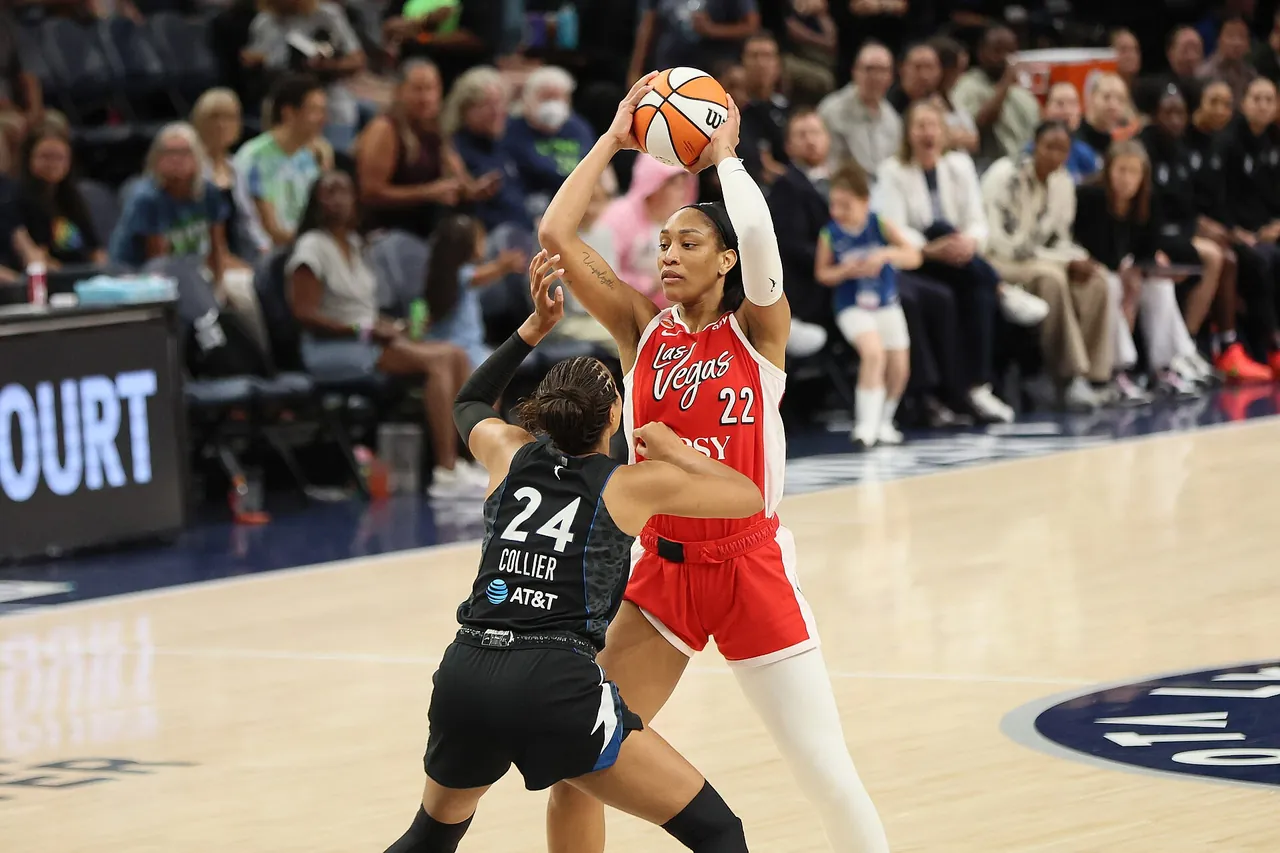 A'ja Wilson of the Las Vegas Aces holds the ball overhead as Napheesa Collier of the Minnesota Lynx defends, August 8, 2026
