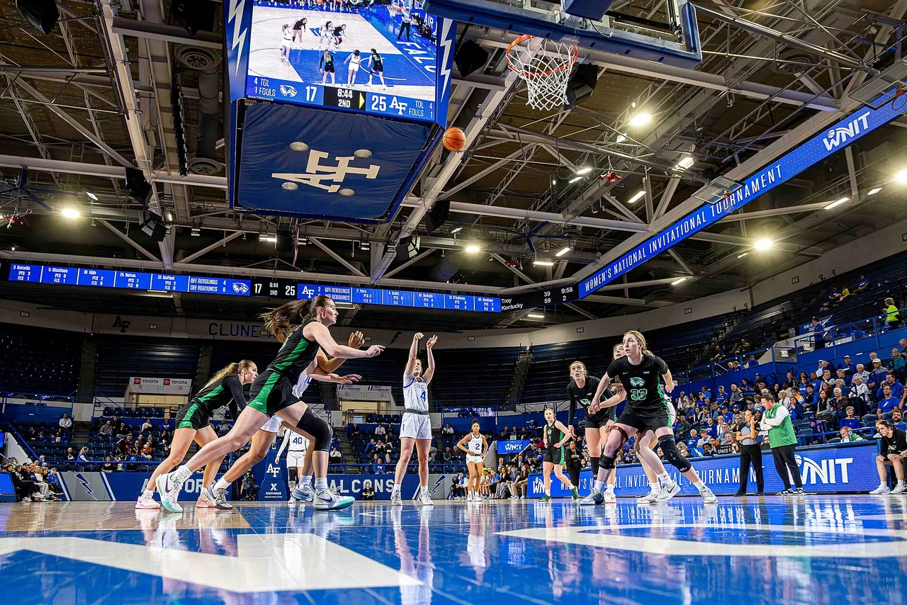 A wide view of a college arena during a women's tournament game