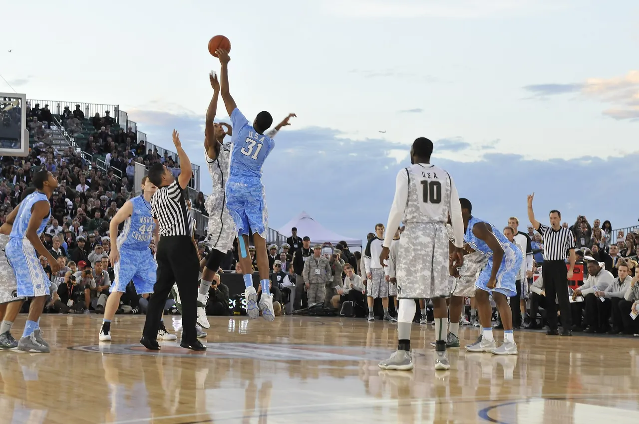 Tip-off of a college game played on a court built on an aircraft carrier deck