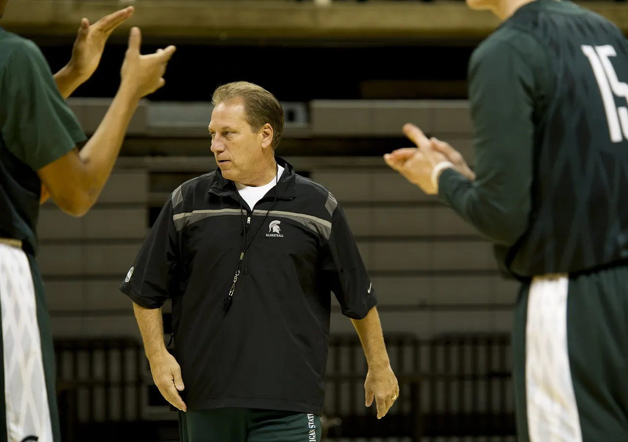 A college head coach runs his team through practice before a game