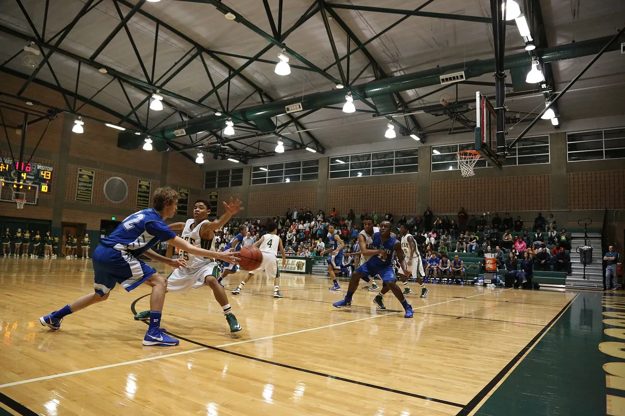 A high school varsity game in a crowded home gym