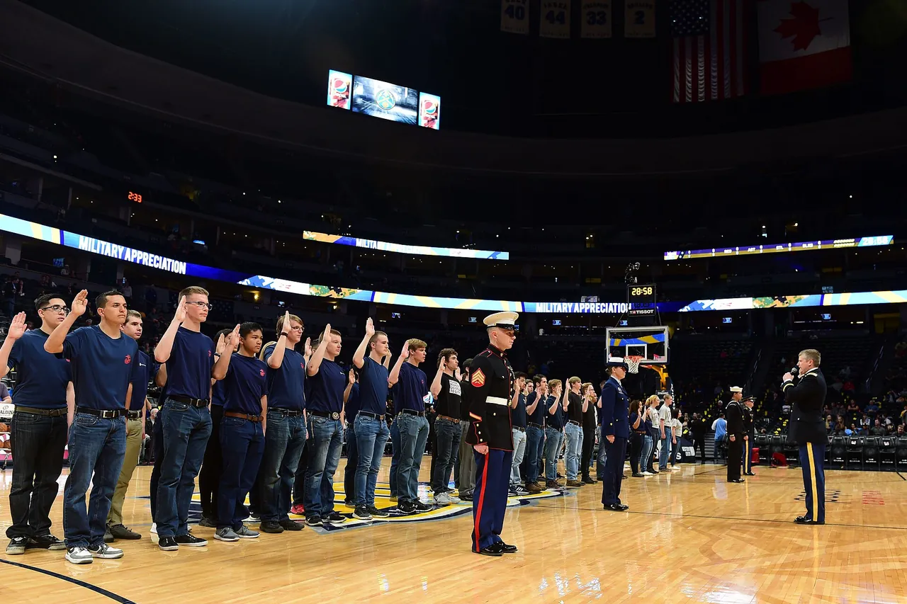 Service members line the baseline of an NBA court before tip-off