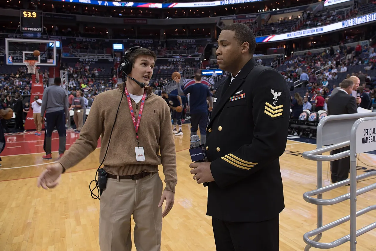 A sideline view of an NBA court and crowd before a game