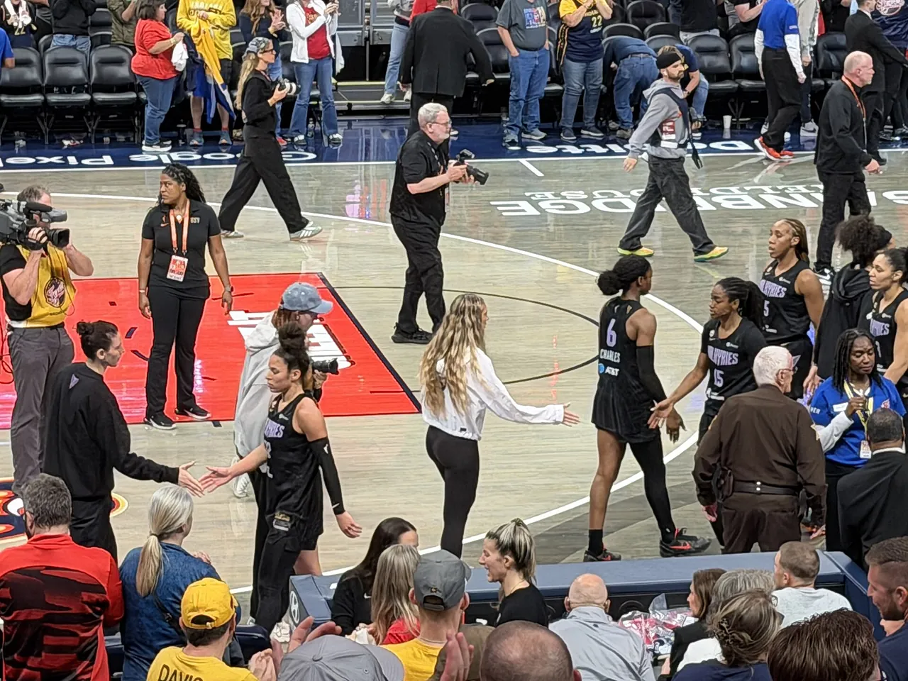 Golden State Valkyries players shake hands on the court after a game against the Indiana Fever in Indianapolis