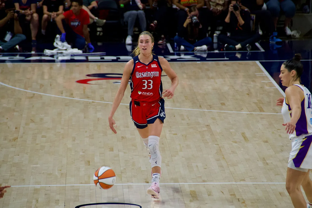 A Washington Mystics guard brings the ball up the court during a WNBA game