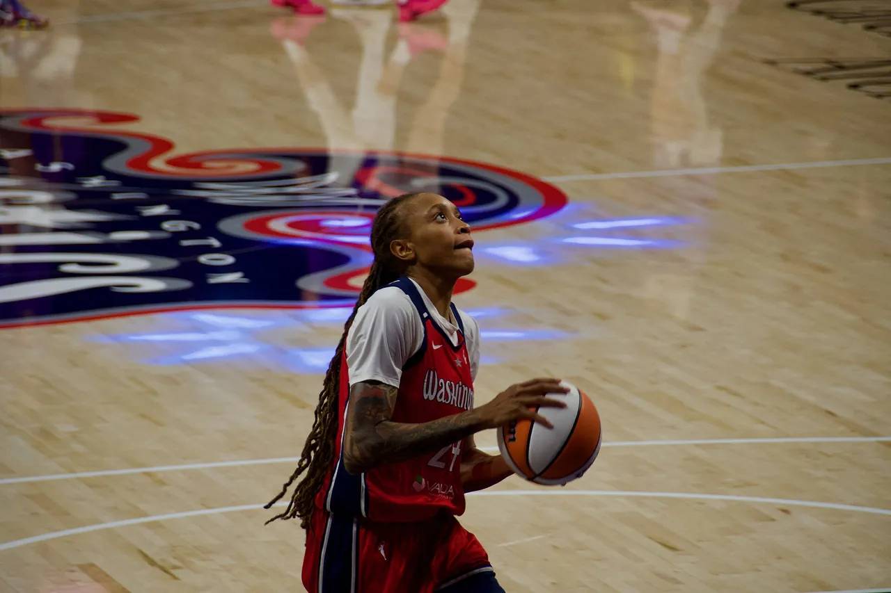 A Washington Mystics player lines up a shot during a WNBA game