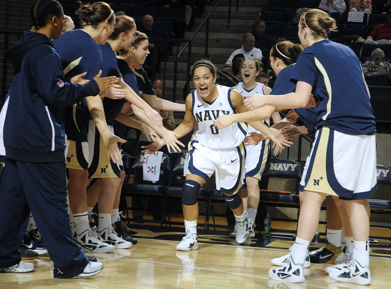 A women's college team greets teammates during pregame introductions