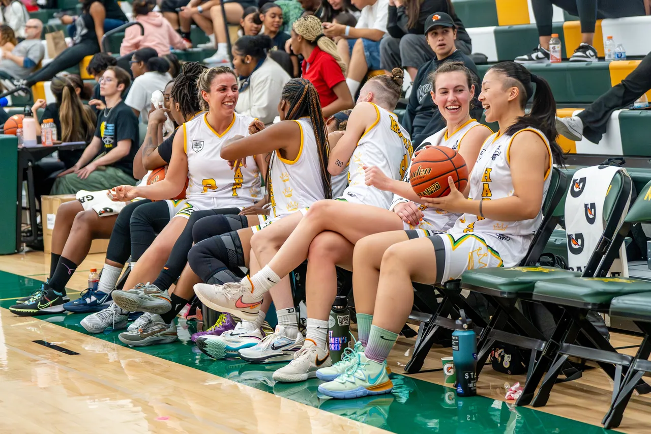 A WPBA bench watches the action from the sideline