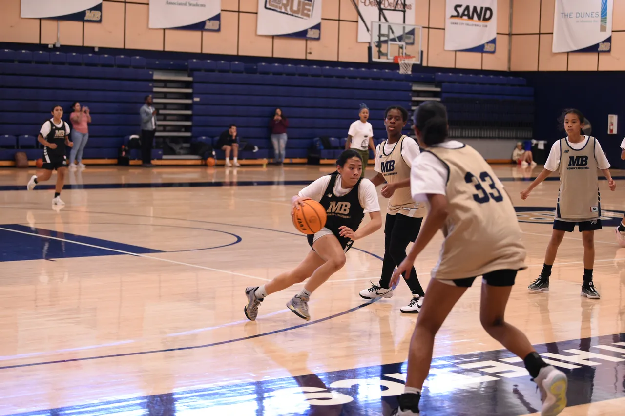 A WPBA guard drives to the basket during a league game in a Bay Area gym