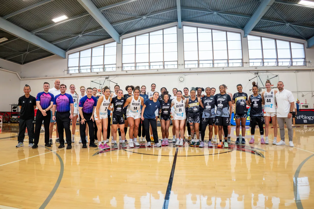Players, coaches and referees from across the Women's Premier Basketball Association line up at center court